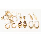 A collection of 9ct gold earrings with various designs, including creoles,