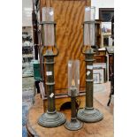 A pair of tall brass candle holders, spring loaded, made by Palmer & Co,