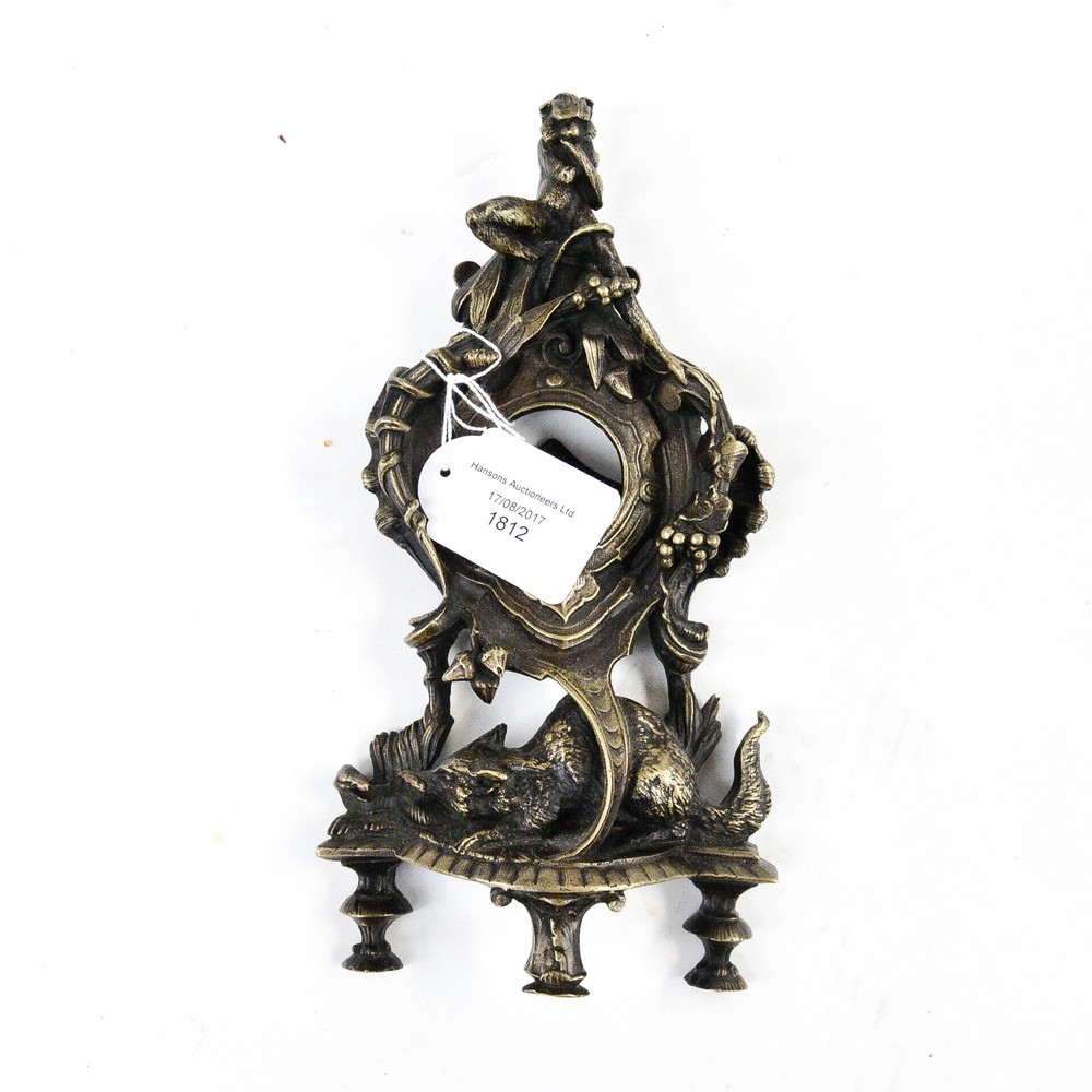 A brass pocket watch stand, German Rococo style with monkey,