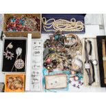 A large quantity of assorted vintage costume jewellery to include glass and hardstone set bangles,