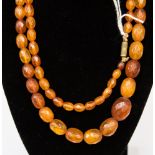 A string of faceted amber type beads, with graduated oval beads, ranging from 8mm - 20mm,