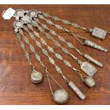A circa 1900 Continental Chatelaine, in white metal with eight accessories, including a needle box,