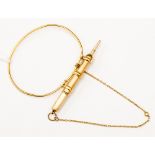 A 15ct gold wire bangle with propelling pencil, complete with safety chain,