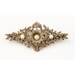 An Edwardian diamond, pearl and yellow/white metal brooch, set with three pearls,