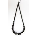 A late 19th century jet style necklace, with graduated faceted beads.