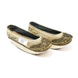 A pair of late 19th Century Chinese silk and embroidered boatshape shoes.