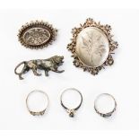 A bronze lion, Victorian silver brooches,