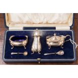 A cased Mappin and Webb cruet set, Birmingham 1950, with original blue glass liners,