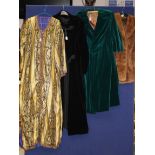 A collection of assorted vintage textiles to include a green velvet coat, black velvet coat,