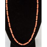 A string of coral type beads on 9ct gold clasp