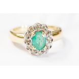 A 9ct gold ring set with an oval emerald to the centre,