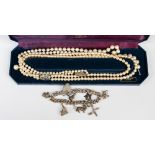 A single sting of pearls, with a double string of faux pearls and a white metal charm bracelet,