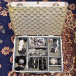 A collection of camera lenses in briefcase, including Sony, Vivitar,