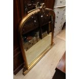 A gilt over mantle mirror