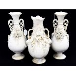 A pair of Parian twin handled vases,