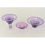 Three graduated Adrian Sankey purple glass bowls