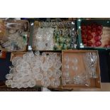 A large collection of glassware, including cut glass sets, jug, vases, dressing table set,