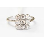 A diamond floodlight unmarked white gold ring, nine round old cut diamonds bead and rub over set,