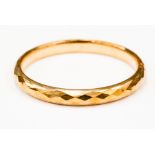 A 9ct gold faceted hollow bangle, width of bangler approx 10mm,diameter approx 65mm,