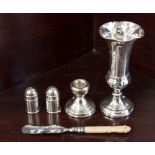 Two silver peppers, silver candlestick, silver posy vase and silver butter knife, all Birmingham,