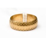 A 9ct gold wedding band, engraved cross design decoration, band width approx 5.