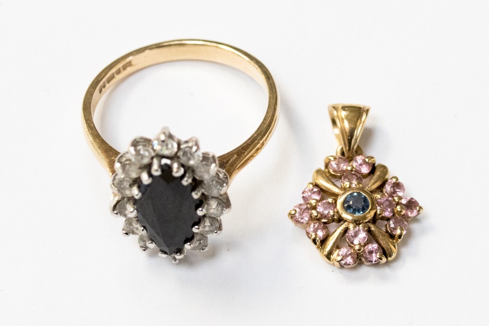 A 9ct gold dress ring with a marquise sapphire to the centre and white stone surround, size O,