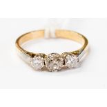 An 18ct yellow gold and diamond three stone ring, central diamond weighing approx .