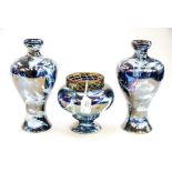 A Staffordshire ceramics garniture with purple lustre glaze with hand decorated scuff detail,