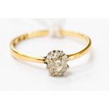 An 18ct gold and platinum diamond solitaire ring, claw set with an old cut diamond approx 0.