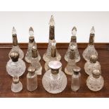 A collection of fifteen silver topped cut glass scent bottles, mostly early 20th Century and later,