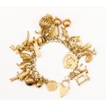 A 9ct charm bracelet with numerous charms including puzzle ball, penknife, horse, and parot,