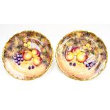 A pair of fruit study cabinet plates, 12 inches, signed D.