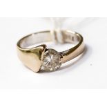 A modern design diamond solitaire and 18ct white gold ring,