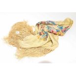 A silk shawl with screen printed floral designs and long fringing,