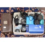 A collection of cameras and lenses including Praktica, Canon,