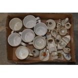 A box containing a collection of crested ware, including tankards,