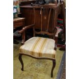 An Edwardian mahogany open armchair, with a shaped and pierced back splat, upholstered seat,