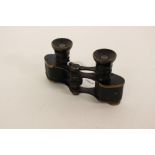 A pair of small sporting field glasses, black coated,