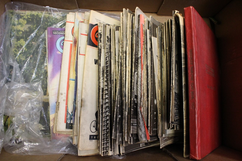 A box of London transport magazines dating from 1940s with a collection of cycling magazines dating