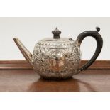 A silver Goldsmiths London silver teapot, London 1887, having raised floral decoration throughout,