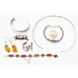 A collection of silver jewellery to include a Victorian pig brooch, a hammer finish silver collar,