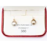 A pair of pearl and diamond stud earrings, in 18ct gold, single coffee coloured pearl studs,
