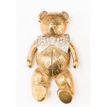 A 9ct gold Teddy Bear brooch, with diamond and white gold dicky bow and ruby eyes,