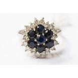 A white metal sapphire and diamond cluster ring,