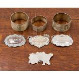 An Australian map wine label, Brandy wine label and three napkin rings 3.36 troy oz approx, 104.