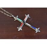 A silver cross set with baguette cut/polished stones,