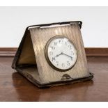 A cased 8 day silver travel clock,