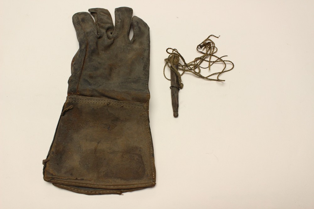 A vintage Falconry glove and lure