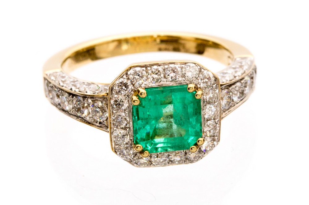 An emerald and diamond 18ct gold octagonal halo cluster ring,