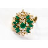 An 18ct gold, green and white stone cluster ring, circa 1960's, floral setting,